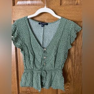 Green top white polka dots with buttons up the front. Size small gently used